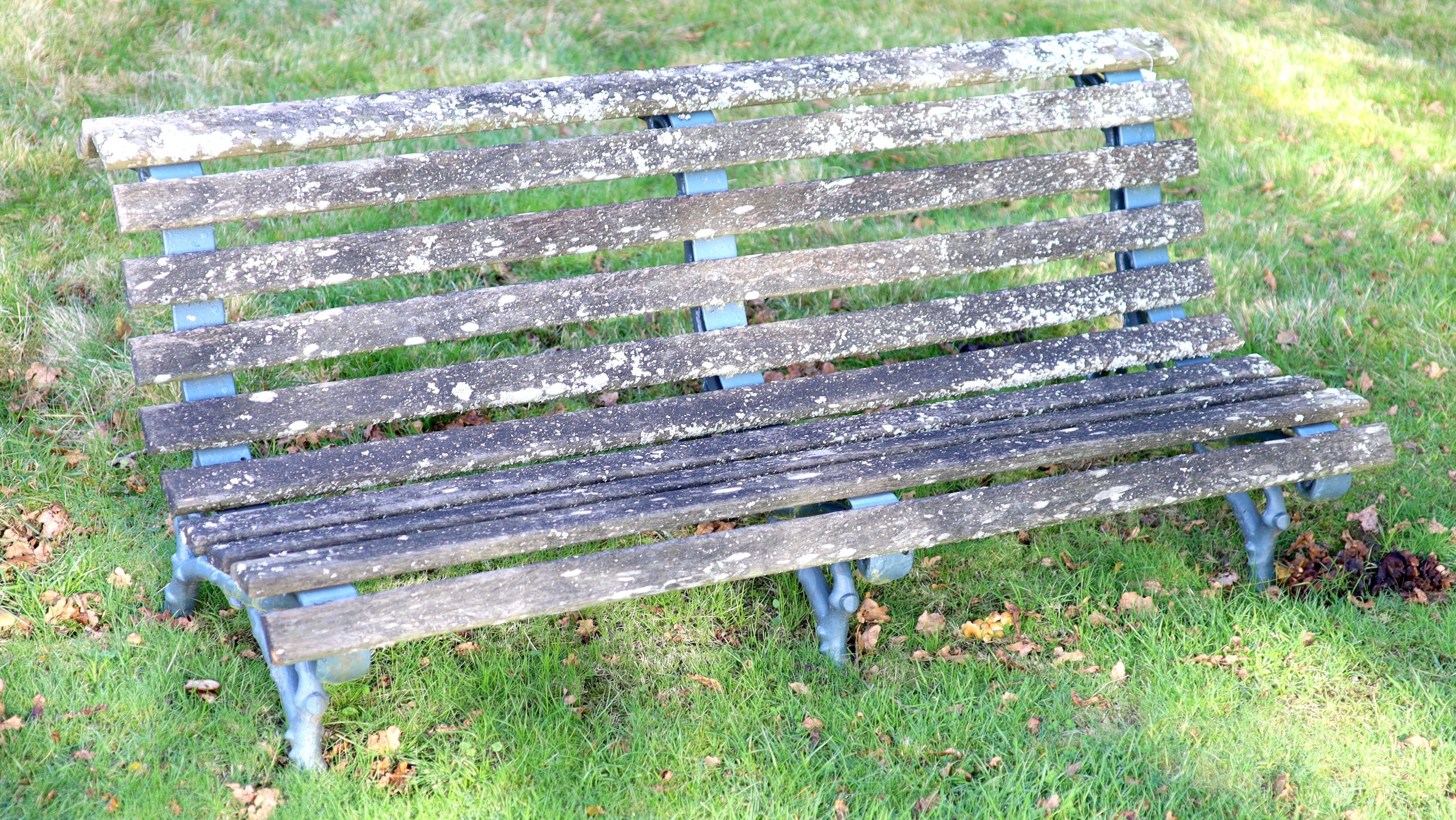 A pair of Coalbrookdale style cast iron and slatted teak garden benches, width 165cm depth 77cm height 60cm